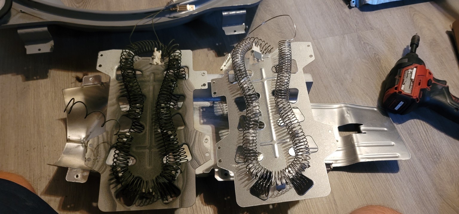 Old and replacement dryer heating elements side by side during a repair.